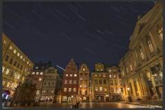 Oldest square in Stockholm - Stortorget,  Trails of Square of Pegasus.
This was the clear night that we got at Stockholm, one clear night out of three, that we were there. The temperatures are low, at the time of this photo, 6 pm in the evening, the temperature was -2° C. You can bear the low temperature for some time, but since star trail photography is boring, the camera is working on its own, and you just have to stand and wait around doing nothing, and it is a long wait, 60-90 minutes just for one star trail. Soon the temperatures start to trouble you. Neelam's fingers were getting numb, even inside the gloves. My toes started paining and legs got extremely cold after some time. Luckily the hotel room was close by, we went back to the room for half an hour to get warmed up and went out again. We could do this three times, and then at 11pm it got unbearable, and we returned for the night.